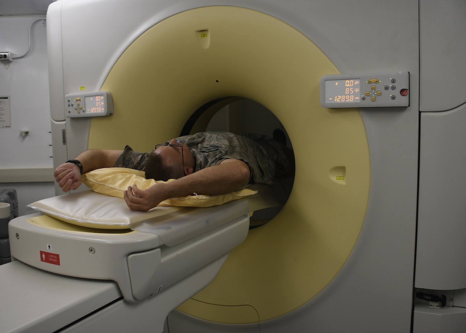 U.S. Air Force Tech. Sgt. Benjamin Zamora, 379th Medical Support Squadron diagnostic sonographer, lies down to test the operability of the new Computed Tomography scanner at Al Udeid Air Base, Qatar, Nov. 21, 2016.