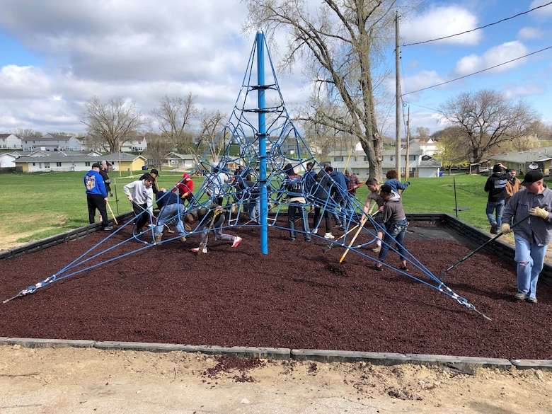 Members of the 55th Communications Group rake mulch April 2019, at Peter Sarpy Elementary School, Bellevue. The squadron volunteers helped install a new playground for the school. (U.S. Air Force courtesy photo)