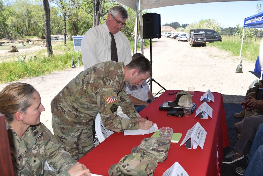 San Francisco District Commander LTC Travis Rayfield signs a design agreement for habitat restoration on a section of the Dry Creek near Healdsburg, Calif.