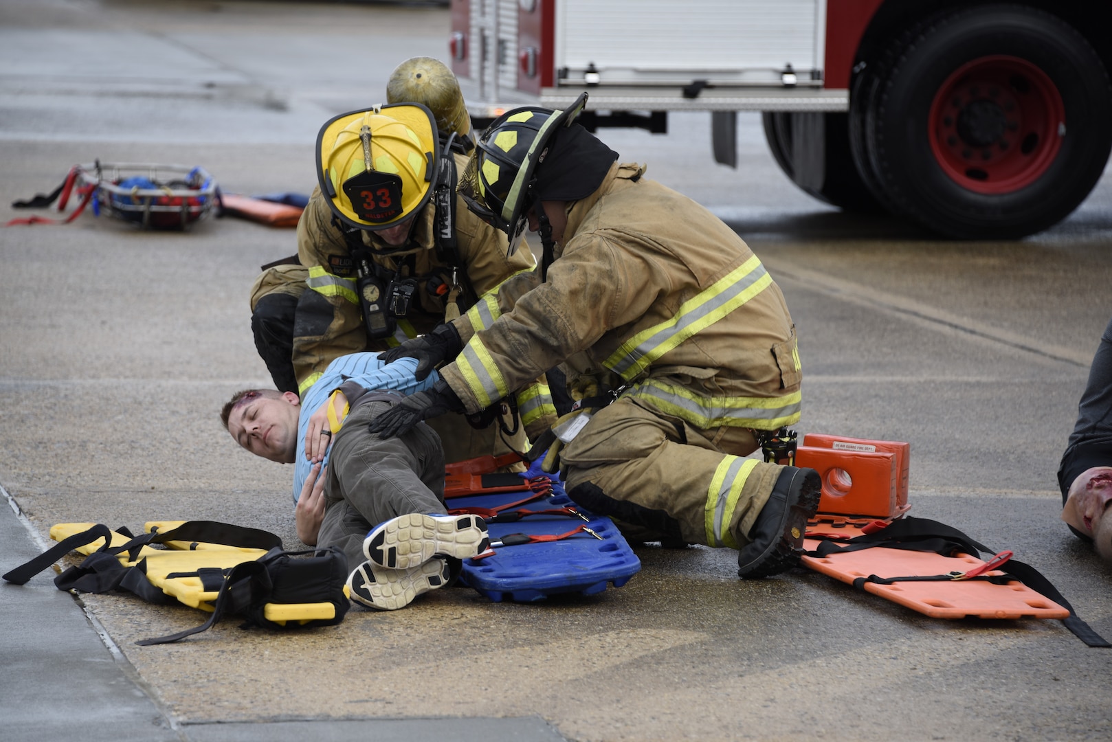 166th Civil Engineer Squadron firefighters ease a victim onto a rescue stretcher during Operation Blue Skywalker, April 10, 2019 at Delaware National Guard Base, Del. Crash victims were subsequently take to St. Francis medial Center. (U.S. Air Force photo by Mr. Mitch Topal)