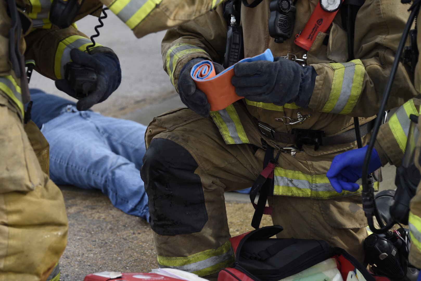 First responders from the 166th Civil Engineer Squadron firefighters apply a compression bandage to a crash victim during Operation Blue Skywalker, April 10, 2019 at Delaware National Guard Base, Del. 166th CES firefighters were first on scene at the mock disaster site. (U.S. Air Force photo by Mr. Mitch Topal)