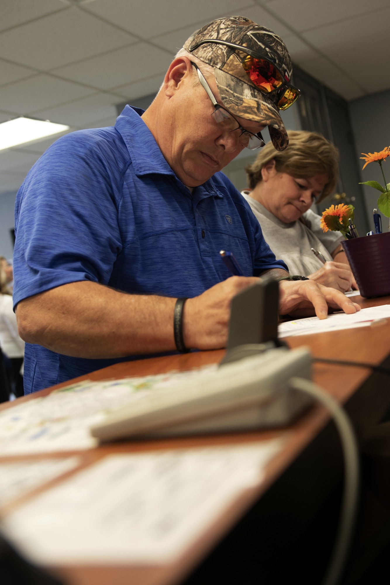 Brian and Donna "Denise" Bradford, parents of Airman 1st Class Brain Bradford, sign to receive an Air Force Family Forever member ID card in the Biloxi Visitors Center at Keesler Air Force Base, Mississippi, April 23, 2019. Brian died while participating in a training exercise at Ramstein Air Base, Germany. As surviving parents of a service member, Michael and Donna obtained an ID card for recognition and installation access so they can attend events and access Airman and Family Readiness Center referral services. (U.S. Air Force photo by Airman Seth Haddix)