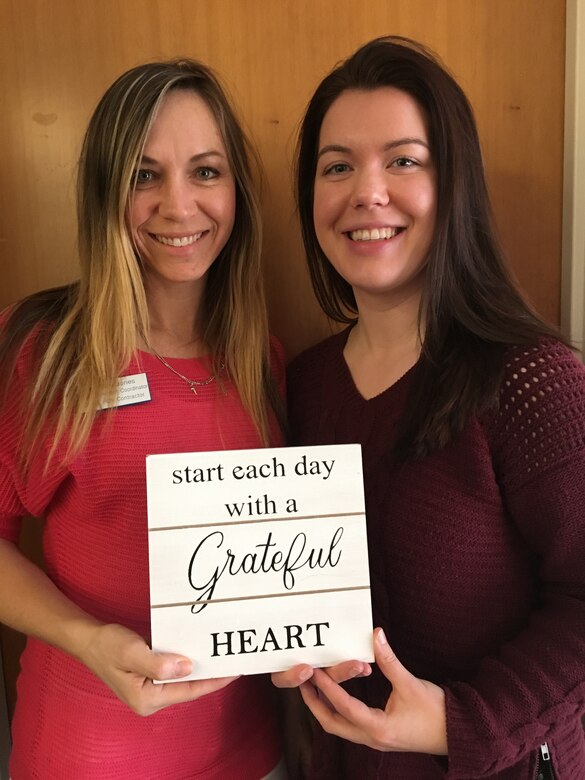 Michelle Jones and Anna Orlov, both Civilian Health Promotion Services coordinators, pose with a gratitude sign.