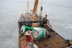 Members of the Coast Guard Cutter William Tate perform buoy tending operations on the Delaware River during a period of extreme cold, Jan. 9, 2018. The cold period caused many buoys in the upper and lower Delaware River to go off-station and require care and maintenance.