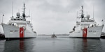 A Coast Guard Station Boston crew transits between Coast Guard Cutter Escanaba and Coast Guard Cutter Spencer in Boston on Nov. 24, 2014. The Escanaba and Spencer are 270-foot Famous-class medium endurance cutters.