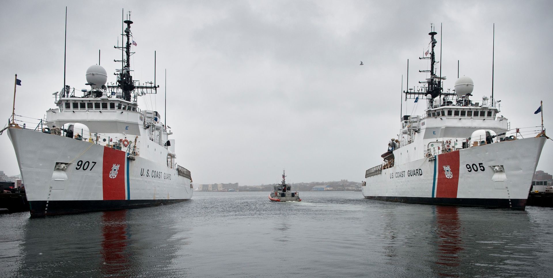 A Coast Guard Station Boston crew transits between Coast Guard Cutter Escanaba and Coast Guard Cutter Spencer in Boston on Nov. 24, 2014. The Escanaba and Spencer are 270-foot Famous-class medium endurance cutters.