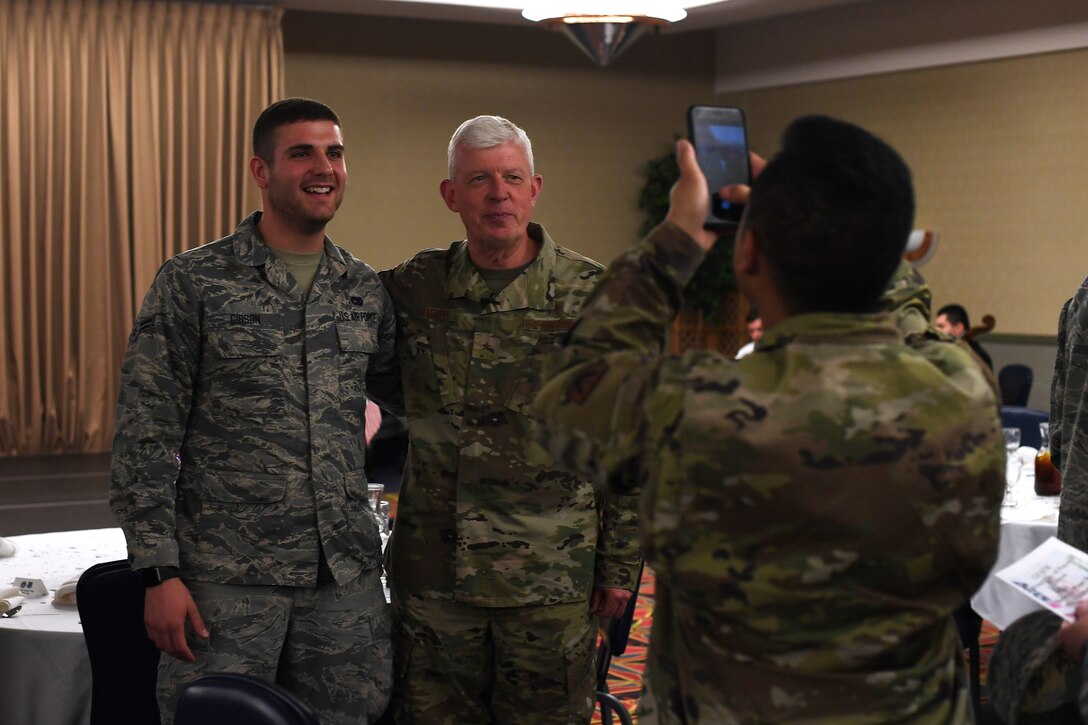 Ch. (Brig. Gen.) Ronald Harvell, Air Force Deputy Chief of Chaplains, stands for a photo beside Airman 1st Class Luke Gibson, 319th Logistics Readiness Squadron ground transportation support operator, following a National Day of Prayer luncheon April 25, 2019, on Grand Forks Air Force Base, North Dakota. During the luncheon, Harvell spoke about how to pray for the military. “You pray for them to win,” he said. “You pray for their success, their safety and their families.” (U.S. Air Force photo by Senior Airman Elora J. Martinez)