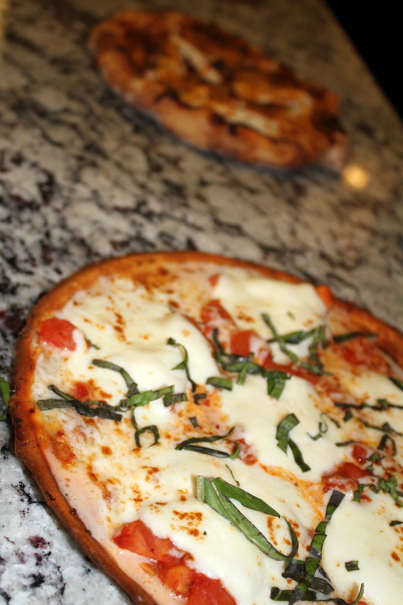 Freshly made Margherita pizza on a cauliflower crust sits ready for General Officer and Senior Executive Service Summit attendees during lunch April 10, 2019, at Joint Base San Antonio-Lackland. The lunch highlighted healthy and nutritious foods being rolled out across the Air Force as part of the Healthy Food Initiative and gave senior leaders a better understanding of the initiative to give Airmen tasty and nutritious food options. (U.S. Air Force photo by Debbie Aragon)