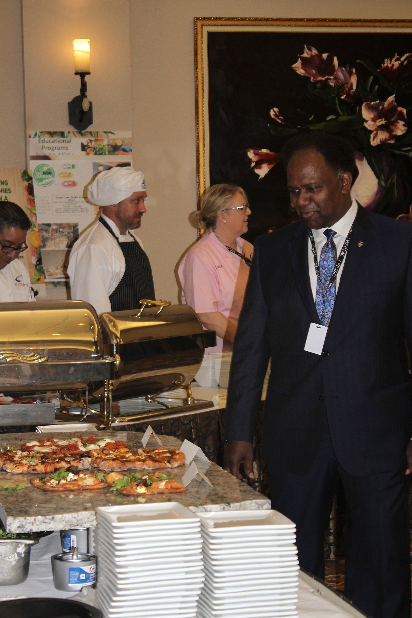 H.L. Larry, Air Force Services director, tours food stations at the Healthy Food Initiative lunch during the General Officer Air Force Services Activity food and beverage members prepared various healthy and nutritious food items to familiarize summit attendees with HFI, a dining concept being rolled out across the Air Force. (U.S. Air Force photo by Debbie Aragon)