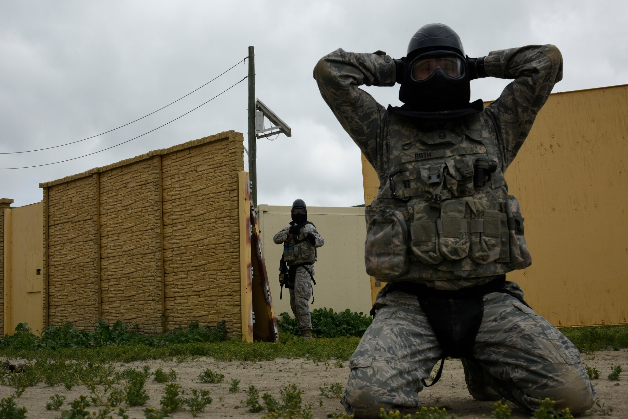 A Defender with the 114th Security Forces Squadron gives commands to an individual simulating an oppositional force during Military Operations in Urban Terrain (MOUT) training at Marine Corps Base Camp Pendleton, California.