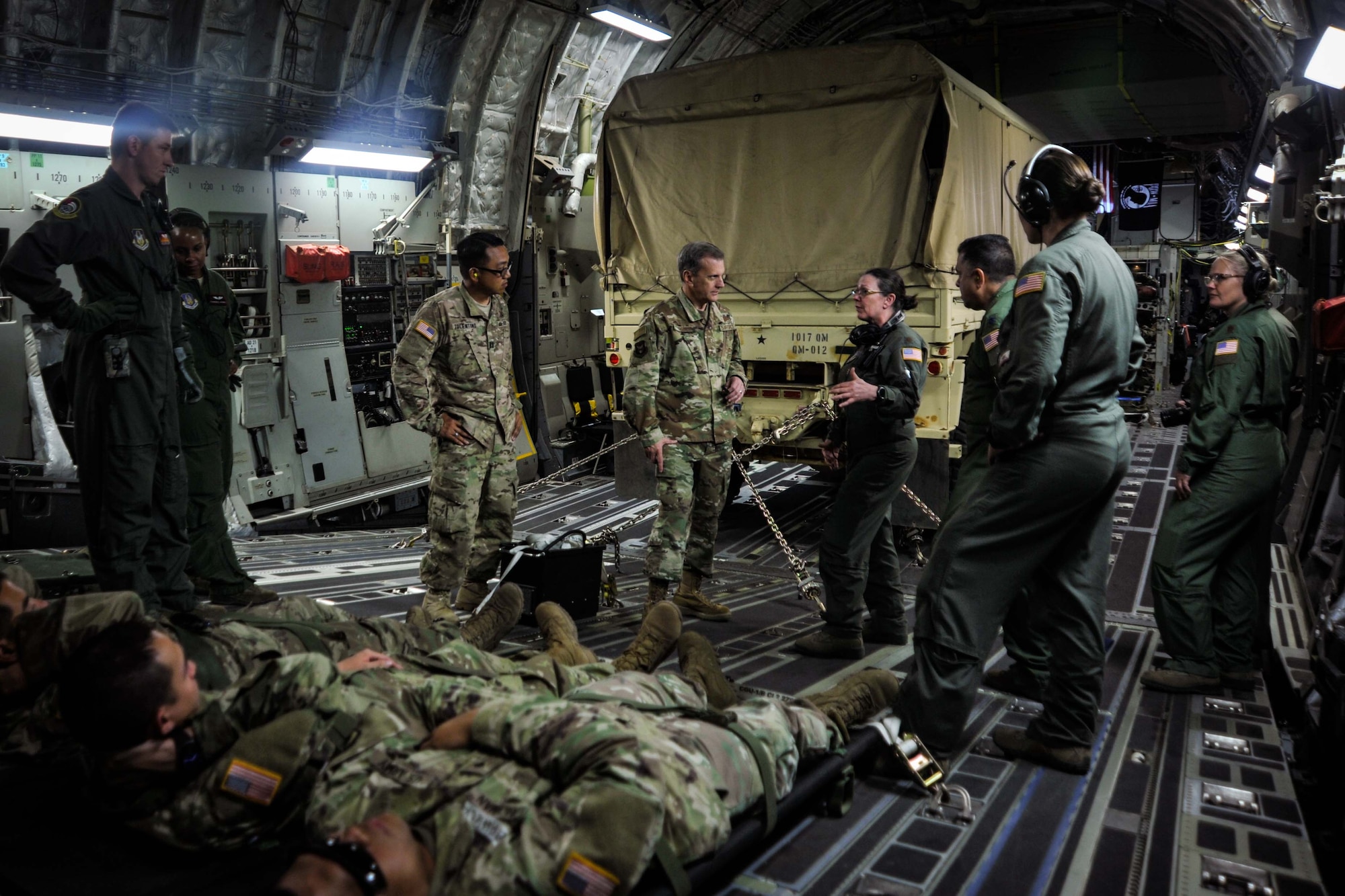U.S. Air Force Maj. Gen. Randall A. Ogden, Fourth Air Force commanding officer, center, learns about the aeromedical evacuation mission from airmen assigned to the 452nd Aeromedical Evacuation Squadron, March Air Reserve Base, aboard a C-17 Globemaster III during exercise Patriot Hook, April 14, 2019, Naval Air Station North Island, California.