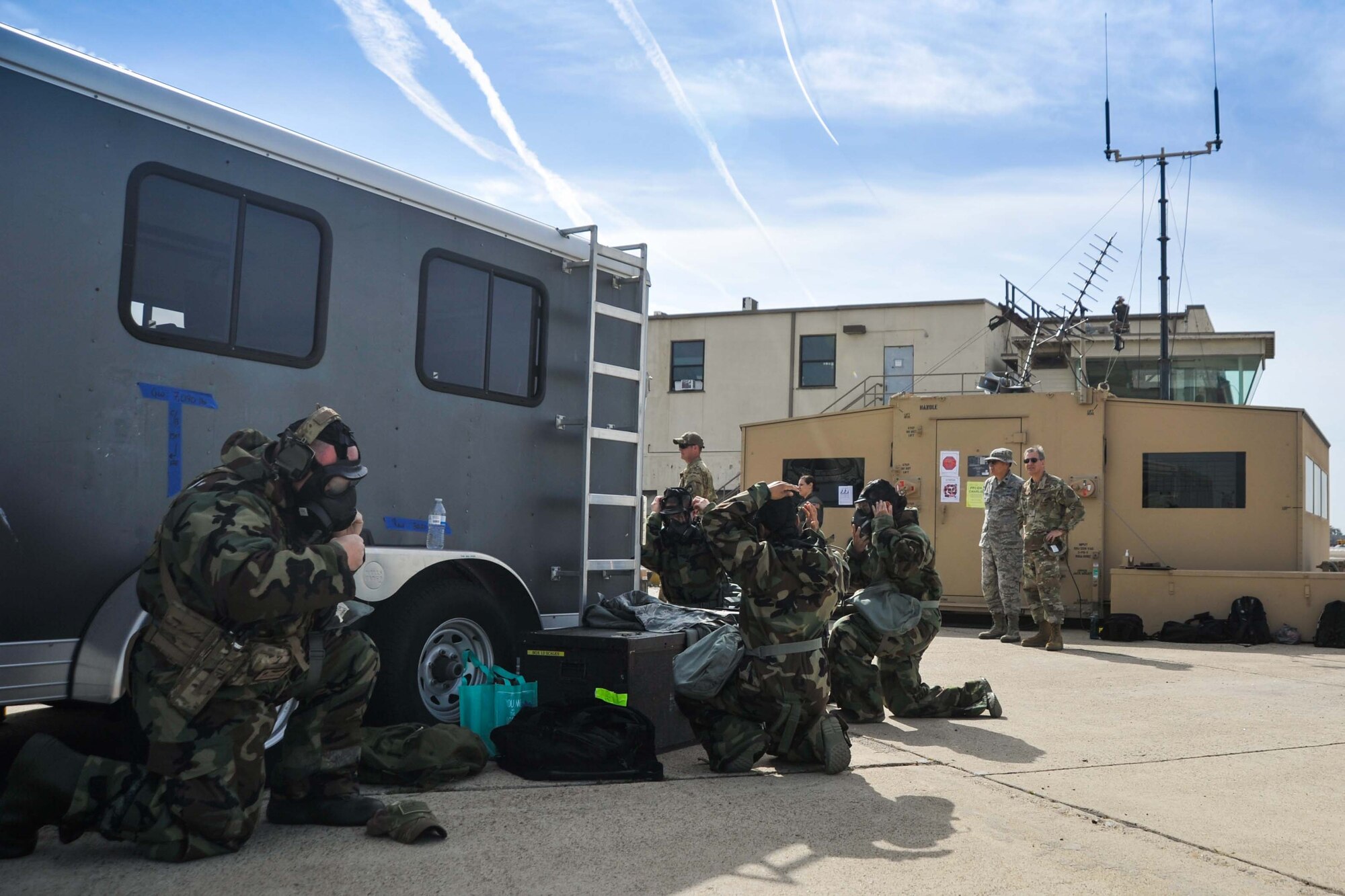 U.S. Air Force airmen don mission-oriented protective posture gear during a visit by Maj. Gen. Randall W. Ogden, commanding officer of Fourth Air Force to exercise Patriot Hook, April 14, 2019, Naval Air Station North Island, California.