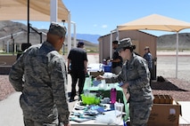 Staff Sgt. Alexis Johnson, Nellis Air Force Base Sexual Assault Prevention and Response volunteer victim advocate, shares information and promotional items with Airmen at Creech AFB, Nevada, April 23, 2019. Because April is Sexual Assault Awareness and Prevention and Child Abuse Prevention Month, helping agencies from Creech and Nellis spent the day informing Airmen and families about what programs are available to raise awareness and help victims of sexual assault and child abuse. (U.S. Air Force photo by Master Sgt. Dillon White)