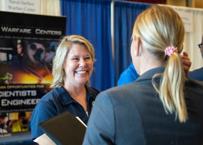 Naval Surface Warfare Center Panama City Division Human Resources Specialist Jen Davis speaks to prospective recruits at a job fair hosted at Florida State University Panama City April 25.