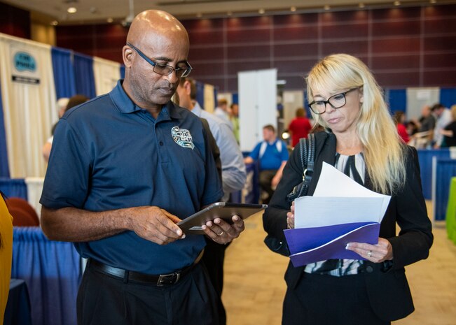 Naval Surface Warfare Center Panama City Division New Professional Development Coordinator Lanshava Booker speaks to prospective recruits at a job fair hosted at Florida State University Panama City April 25.