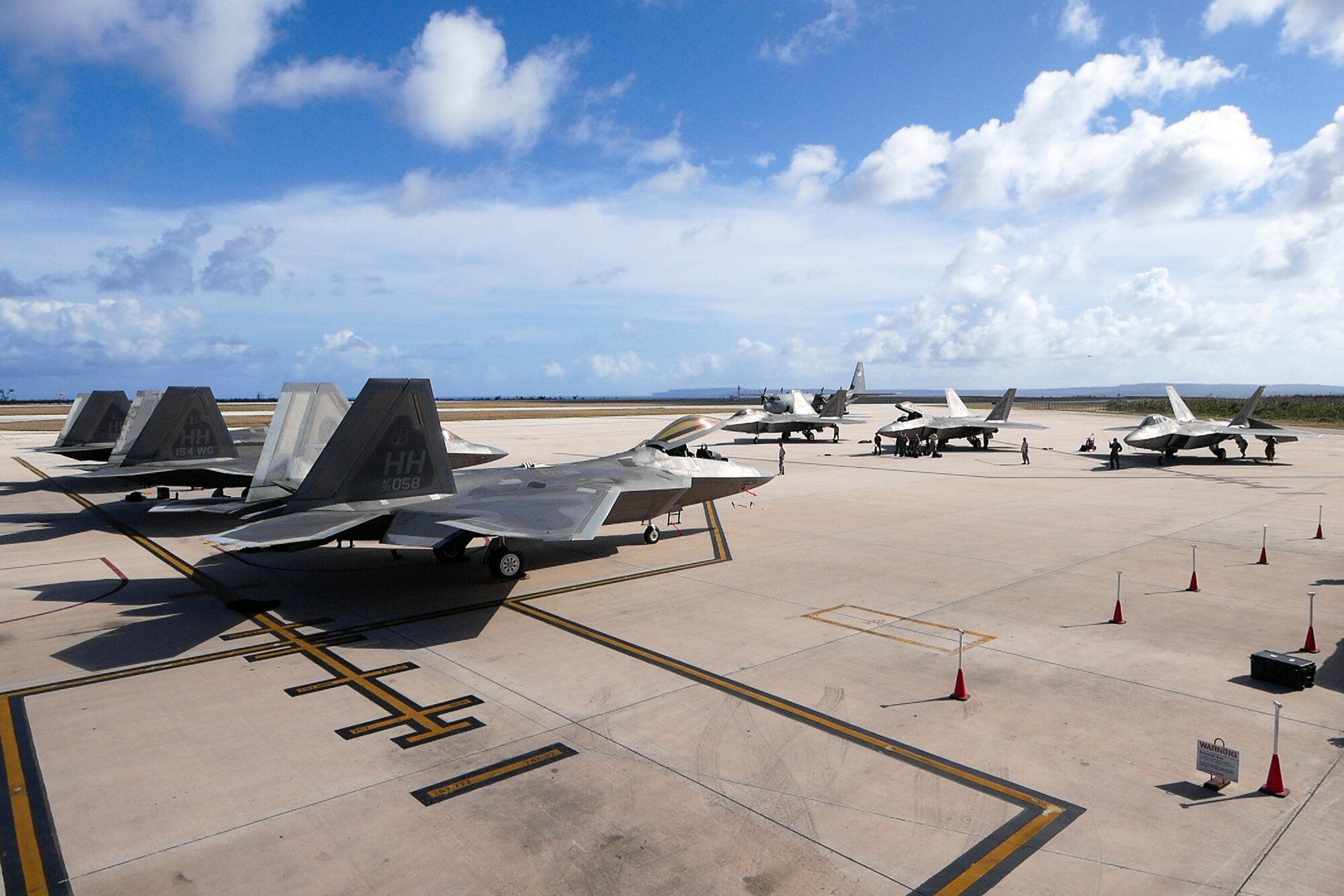 F-22 Raptors park during their inaugural appearance during exercise Resilient Typhoon, at the Francisco C. Ada International Airport, Saipan, April 23, 2019.