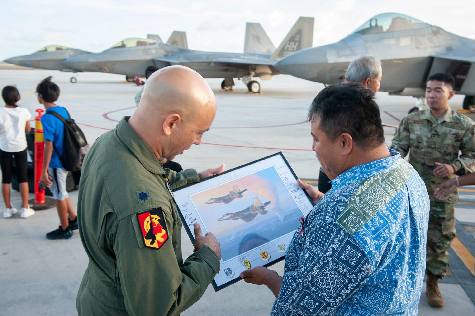 U.S. Air Force Lt. Col. Shane Nagatani, 199th Fighter Squadron commander, presents Ralph Torres, Governor of Saipan, a framed picture at the Francisco C. Ada International Airport, Saipan, April 23, 2019.