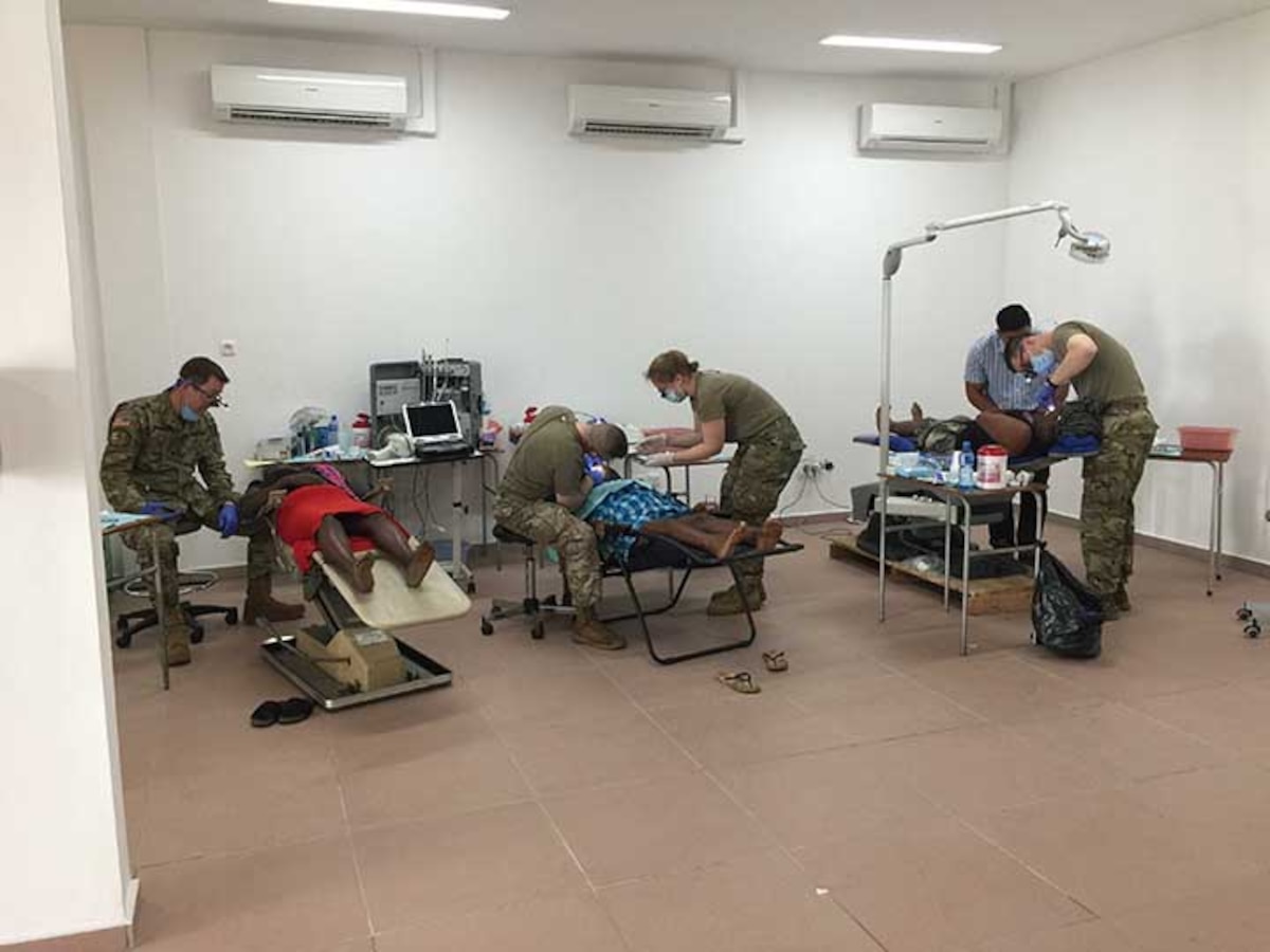 U.S. Army dentists Lt. Col. Eric Unkenholz, Col. Murray Thompson, and Maj. Kevin Donlin and Staff Sgt. Samantha Wempe, dental technician, all with the South Dakota National Guard, perform dental work and tooth extractions on adults and children in Albina, Suriname, April 10, 2019. A SDARNG medical/dental team partnered with Suriname military and civilian medical personnel to assist with ongoing efforts of improving systemic and oral health in the region.