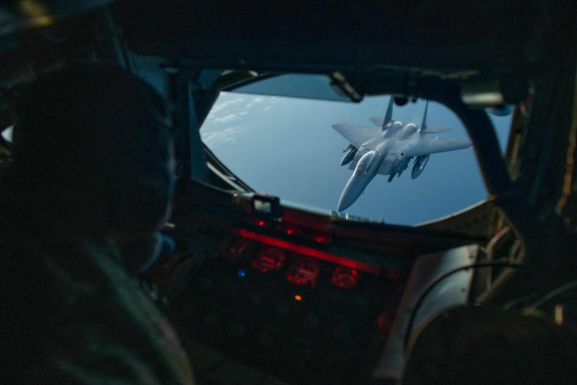 U.S. Air Force Tech. Sgt. Christian Villanueva, 351st Air Refueling Squadron boom operator, refuels an F-15E Strike Eagle assigned to the 48th Fighter Wing at RAF Lakenheath, England during the “FURIOUS 48” readiness exercise over the skies of England, April 24, 2019. The exercise was designed to emphasize the importance of combat skills effectiveness training and test 100th ARW and 48th FW Airmen on their ability to survive and operate in wartime conditions. (U.S. Air Force photo by Senior Airman Luke Milano)
