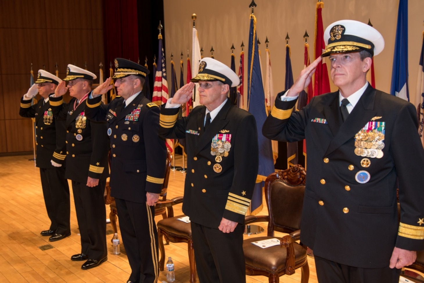 190425-N-TB148-0052 BUSAN, Republic of Korea (April 25, 2019) The official party (from left): Cmdr. Santiago Rodriguez, command chaplain assigned to Commander, U.S. Naval Forces Korea (CNFK); Rear Adm. Michael E. Boyle, commander, CNFK; U.S. Army Gen. Robert B. Abrams, commander, U.S. Forces Korea; Vice Adm. Phillip Sawyer, commander, U.S. 7th Fleet; and Rear Adm. Michael P. Donnelly render a salute during a change of command ceremony at (CNFK) headquarters. During the ceremony, Donnelly relieved Boyle to become CNFK's 37th commander.