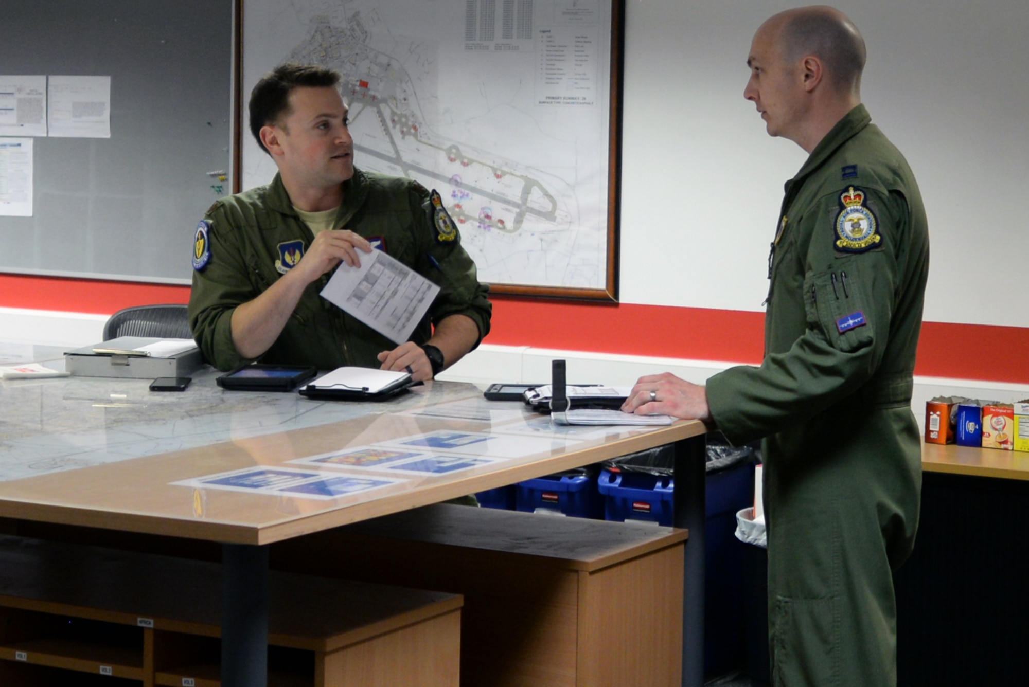 U.S. Air Force Maj. Mike Renna, 351st Air Refueling Squadron aircraft commander, discusses flight plan with U.S. Air Force Capt. Steve Staudinger, 351st Air Refueling Squadron pilot at RAF Mildenhall, England, April 24, 2019. Exercises like Mission Assurance 19-01, provided both aircrew and support personnel at RAF Mildenhall and RAF Lakenheath the opportunity needed to maintain a mission-ready force capable of ensuring the collective defense of the North Atlantic Treaty Organization alliance. (U.S. Air Force photo by Senior Airman Benjamin Cooper)