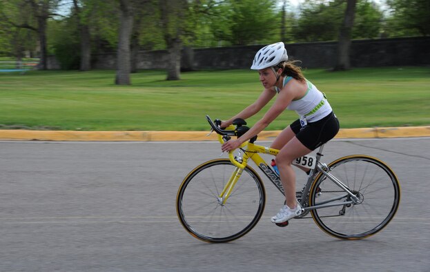 Bright clothing and a helmet are worn by a cyclist. Visibility is a large factor of bicycle safety and should be considered at any time of day.  (U.S. Air Force photo/Airman 1st Class Katrina Heikkinen)