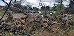Louisiana National Guard members with the 527th Engineer Battalion, headquartered in Ruston, Louisiana, clean debris after tornados touched down in their community, April 25, 2019.