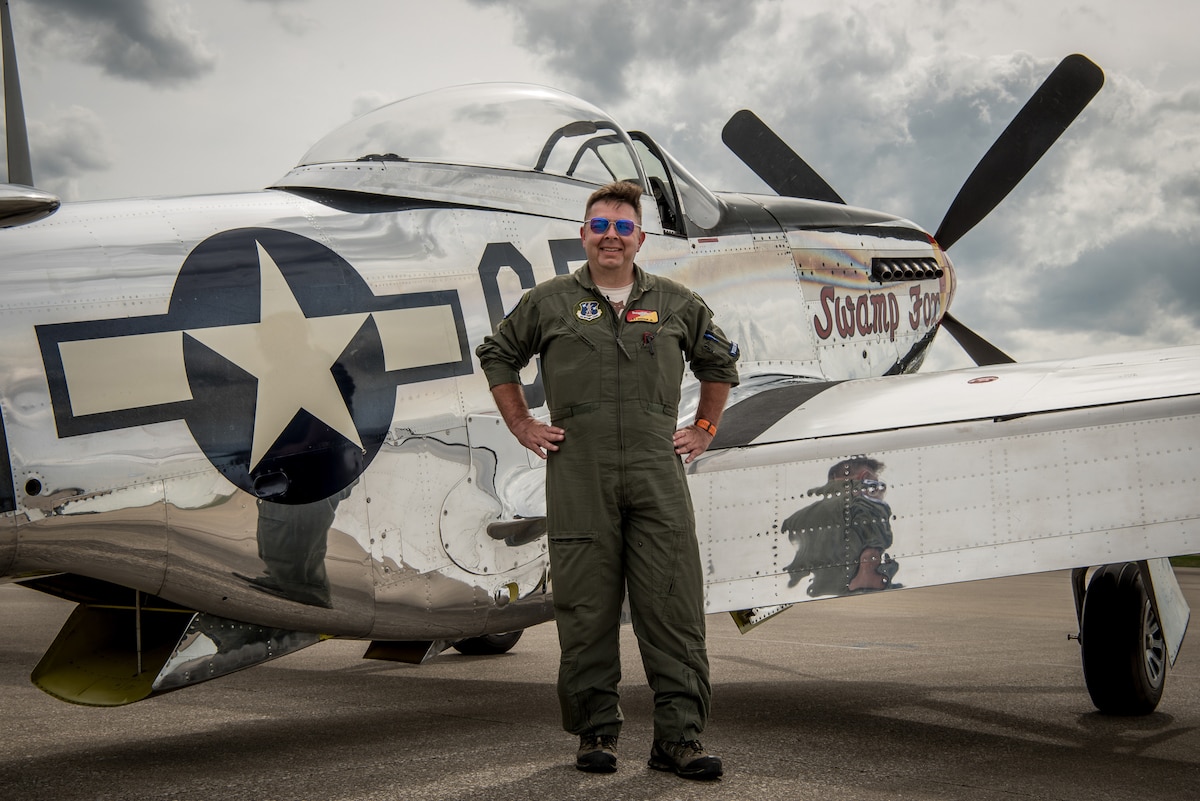 Robert “R.T.” Dickson Jr. poses with "Swamp Fox," his restored P-51 Mustang aircraft, on the flight line of the Kentucky Air National Guard Base in Louisville, Ky., April 11, 2019. This exact aircraft was once assigned to the Kentucky Air Guard when the Mustang served as the unit’s primary airframe from 1947 to 1953. (U.S. Air National Guard photo by Staff Sgt. Joshua Horton)