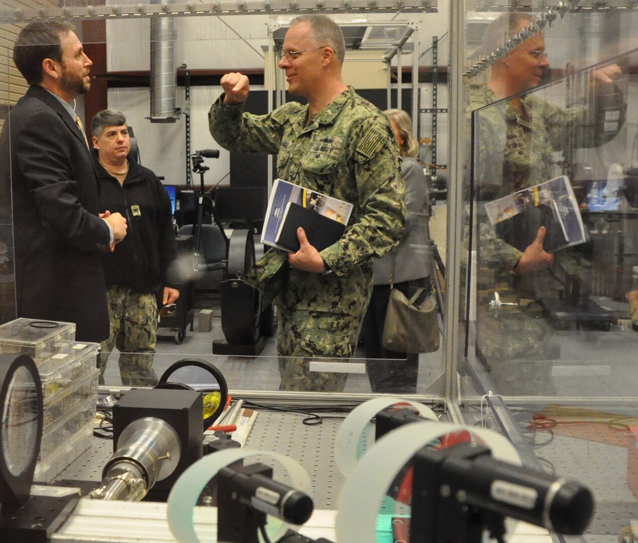 IMAGE: DAHLGREN, Va. (April 17, 2019) – Rear Adm. Eric Ver Hage – commander of the Naval Sea System Command (NAVSEA) Warfare Centers – discusses high energy laser testing with Dr. Chris Lloyd, High Energy Laser Lethality lead at Naval Surface Warfare Center Dahlgren Division (NSWCDD). Lloyd emphasized that lethality lab efforts – including rigorous modeling and testing against target materials to ensure high energy laser systems meet warfighter requirements – are growing while keeping pace with an increased demand signal for fielded high energy laser weapons. Meanwhile, Lloyd’s team is coordinating and collaborating with organizations throughout the Department of Defense and elsewhere to accomplish common goals. Pictured at the NSWCDD Laser Lethality Laboratory left to right are Lloyd, Capt. Andrew Arnold, NSWC chief of staff, and Ver Hage.