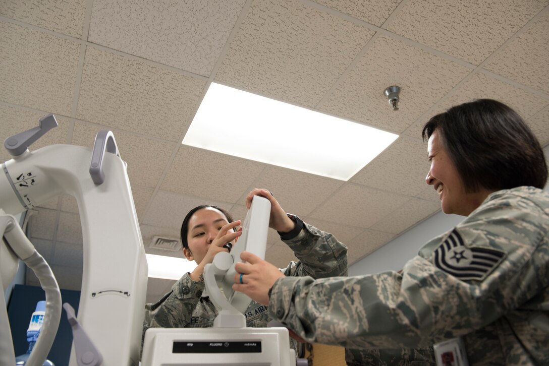 Tech. Sgt. Kristine Richardson, 39th Medical Support Squadron biomedical equipment NCO in charge, right, and Senior Airman Kirsten Lee, 39th MDSS biomedical equipment technician, left, fix an X-ray machine March 29, 2019, at Incirlik Air Base, Turkey.