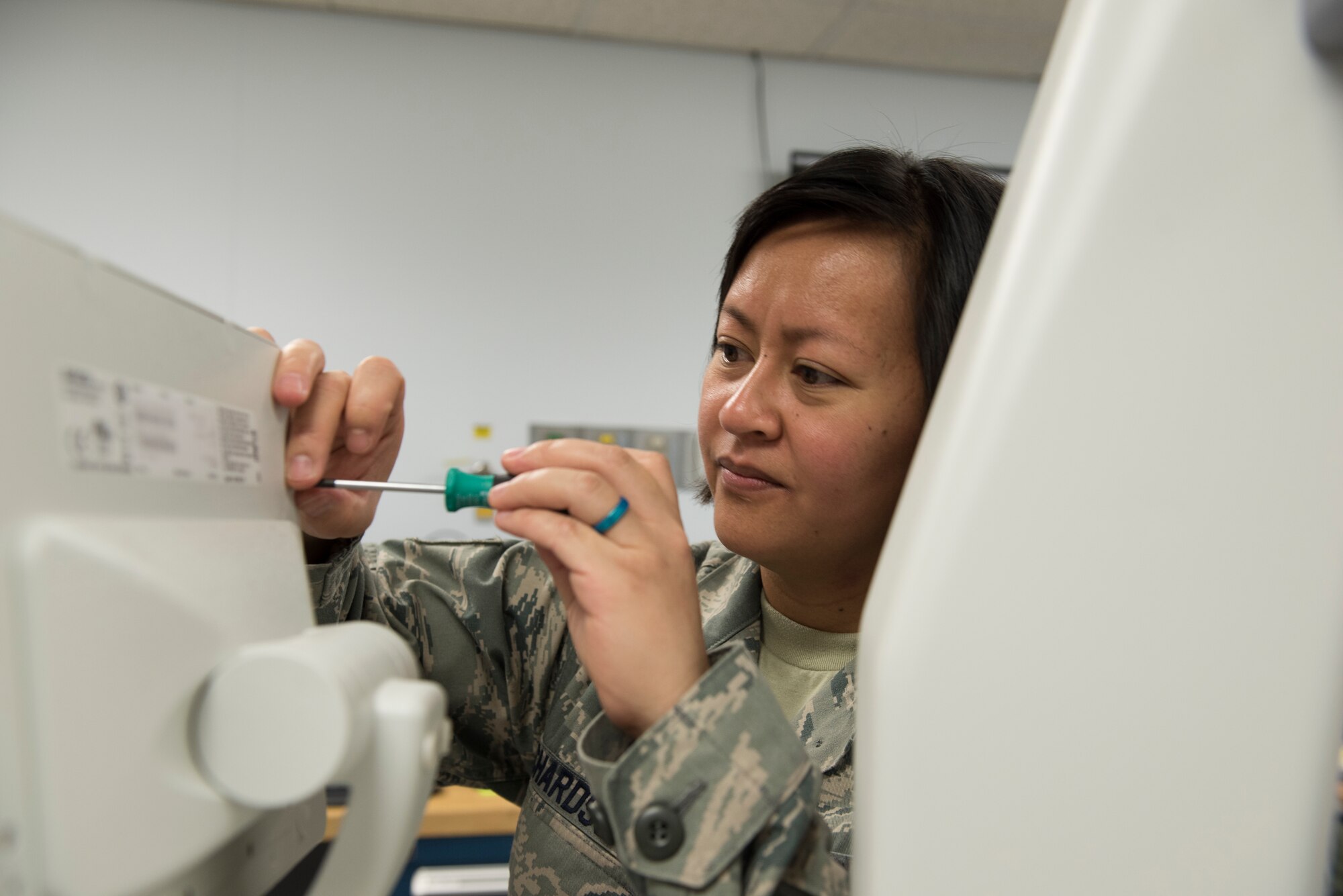 Tech. Sgt. Kristine Richardson, 39th Medical Support Squadron biomedical equipment NCO in charge, fixes the screen on an X-ray machine March 29, 2019, at Incirlik Air Base, Turkey.