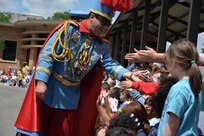 Roger C. Hill III, King Antonio XCVII, is greeted by Lackland Elementary Students during his visit to the campus April 18 where he handed out Fiesta medals.