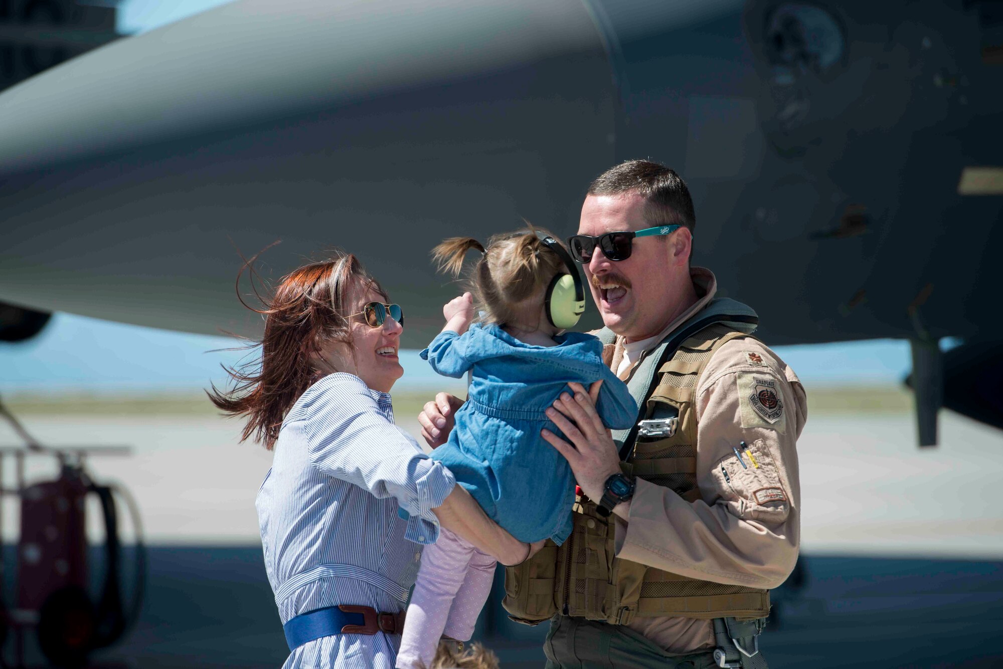 An Airman hugs his family as he returns from a six-month deployment