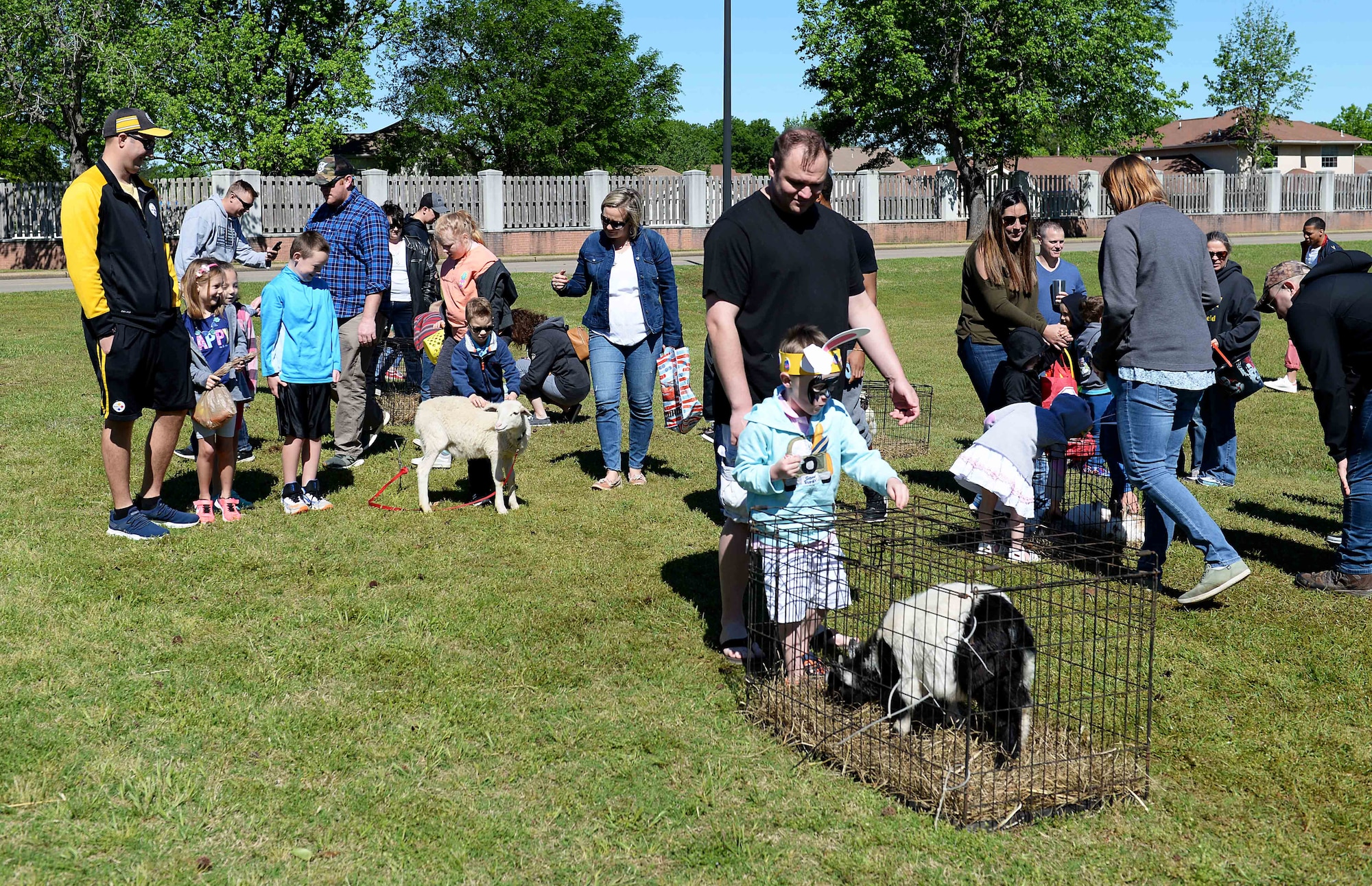 Team BLAZE members check out different animals in the petting zoo during the 14th Force Support Squadron Spring Fling and Easter Egg Hunt April 20, 2019, on Columbus Air Force Base, Miss. The petting zoo featured animals including goats, sheep, ducklings and more for attendees to see and touch. (U.S. Air Force photo by Airman Hannah Bean)
