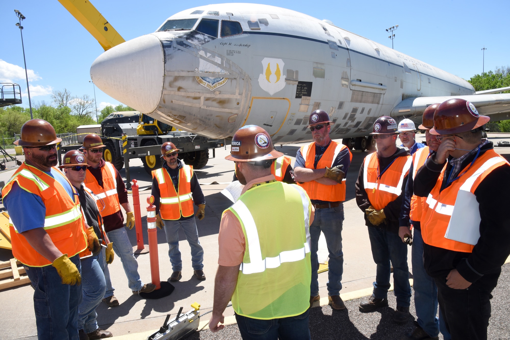 Josh Harvey, crash damaged disabled aircraft recovery (CDDAR) team chief, gives a safety briefing to his team after all of the equipment has been set up and before they lift the aircraft. During this simulated event, the team was given the scenario that the aircraft's front landing gear had collapsed and they would need to simulate a nose lift with a crane to then tow to a repair facility. Due to high winds Apr. 18, they could only simulate the lift due to safety reasons. (U.S. Air Force photo/Kelly White)
