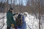 Geoffrey Dominessy, a contracting officer, in the Defense Logistics Agency Troop Support’s Construction and Equipment supply chain, stands next to his dog sled during a trip hosted by Outward Bound for Veterans in February 2019 in Northern Minnesota.