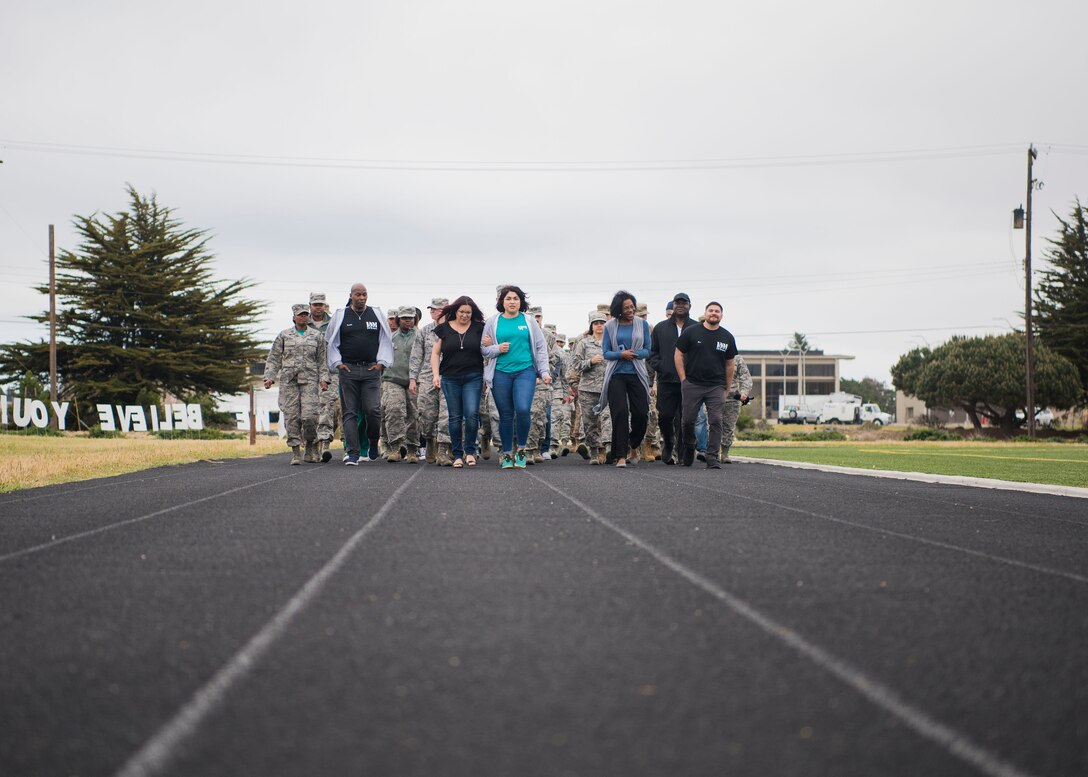 The members who attended during the Sexual Assault Prevention and Response’s Survivor Vigil took a courtesy walk a lap of silence April 19, 2019, at Vandenberg Air Force Base, Calif. The walk around the track provided attendees with time to reflect on the stories shared during the ceremony and show support to those who have survived sexual assault. (U.S. Air Force photo by Airman 1st Class Hanah Abercrombie)