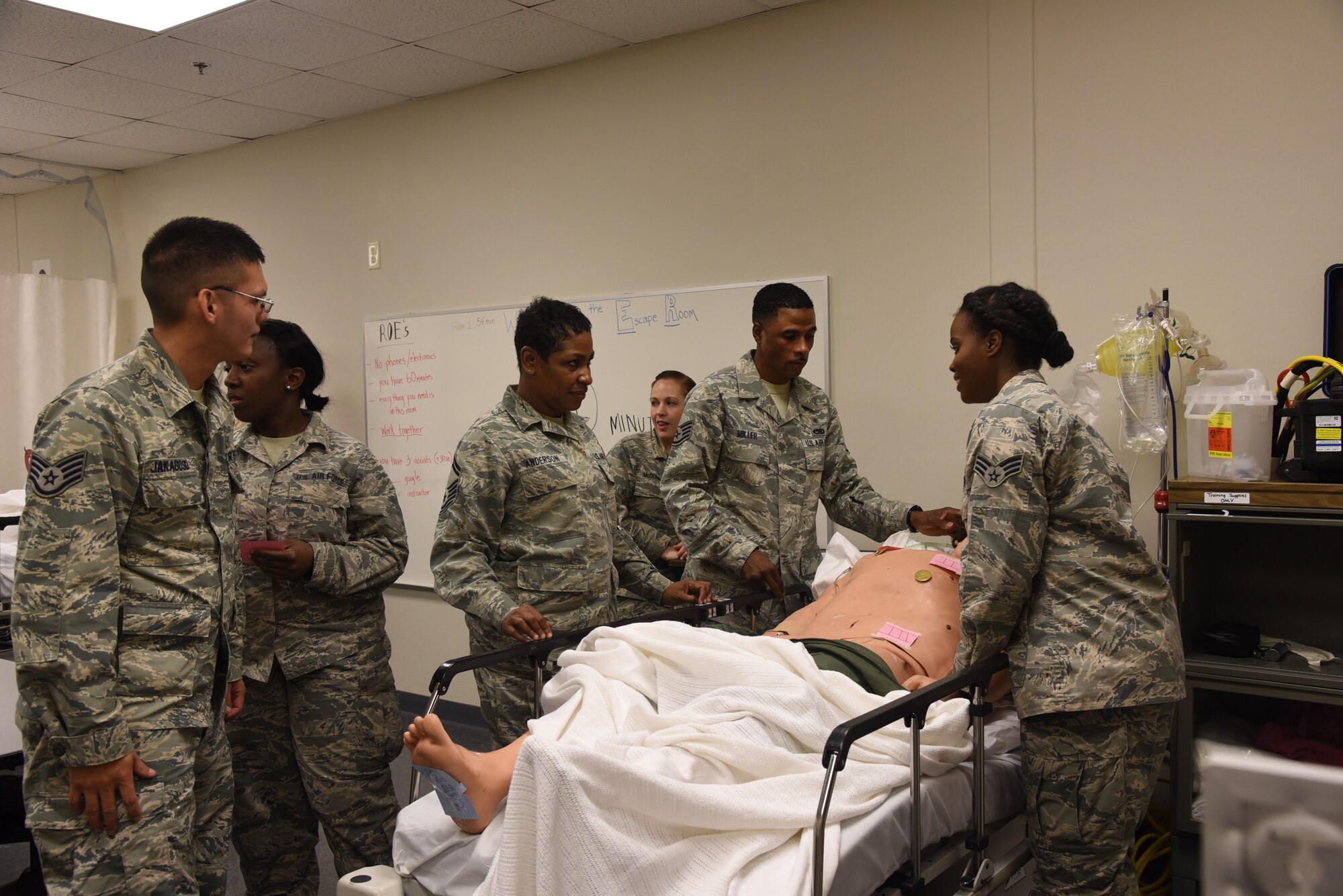 Members of the 403rd Aeromedical Staging Squadron participated in an escape room scenario to maintain their training requirements for medical technicians during the March Unit Training Assembly at Keesler Air Force Base.  The medical technicians had to work together to "save the life" of their patient during the training before they could escape. (U.S. Air Force photo by Jessica L. Kendziorek)
