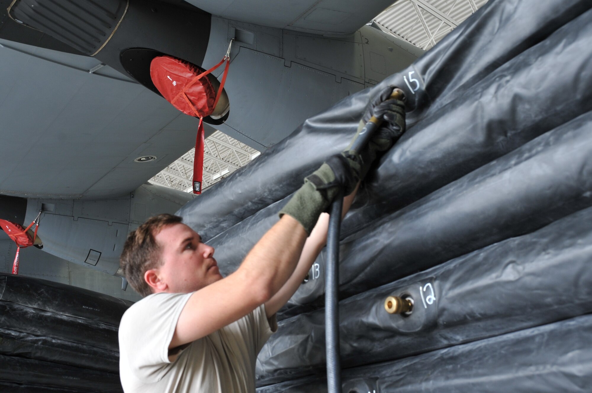Master Sgt. Jay Hommerbocker, 403rd Aircraft Maintenance Squadron flight line expiditer, removes the hoses from the air bags for deflation after completing the exercise. Members of the 403rd Wing Crash, Damaged or Disabled Aircraft Recovery team work together during a training exercise held during the March Unit Training Assembly at Keesler Air Force Base. The CDDAR training is an annual requirement to maintain proficiency and ensure that all equipment is serviceable and operational.  (U.S. Air Force photo by Master Sgt. Jessica Kendziorek)