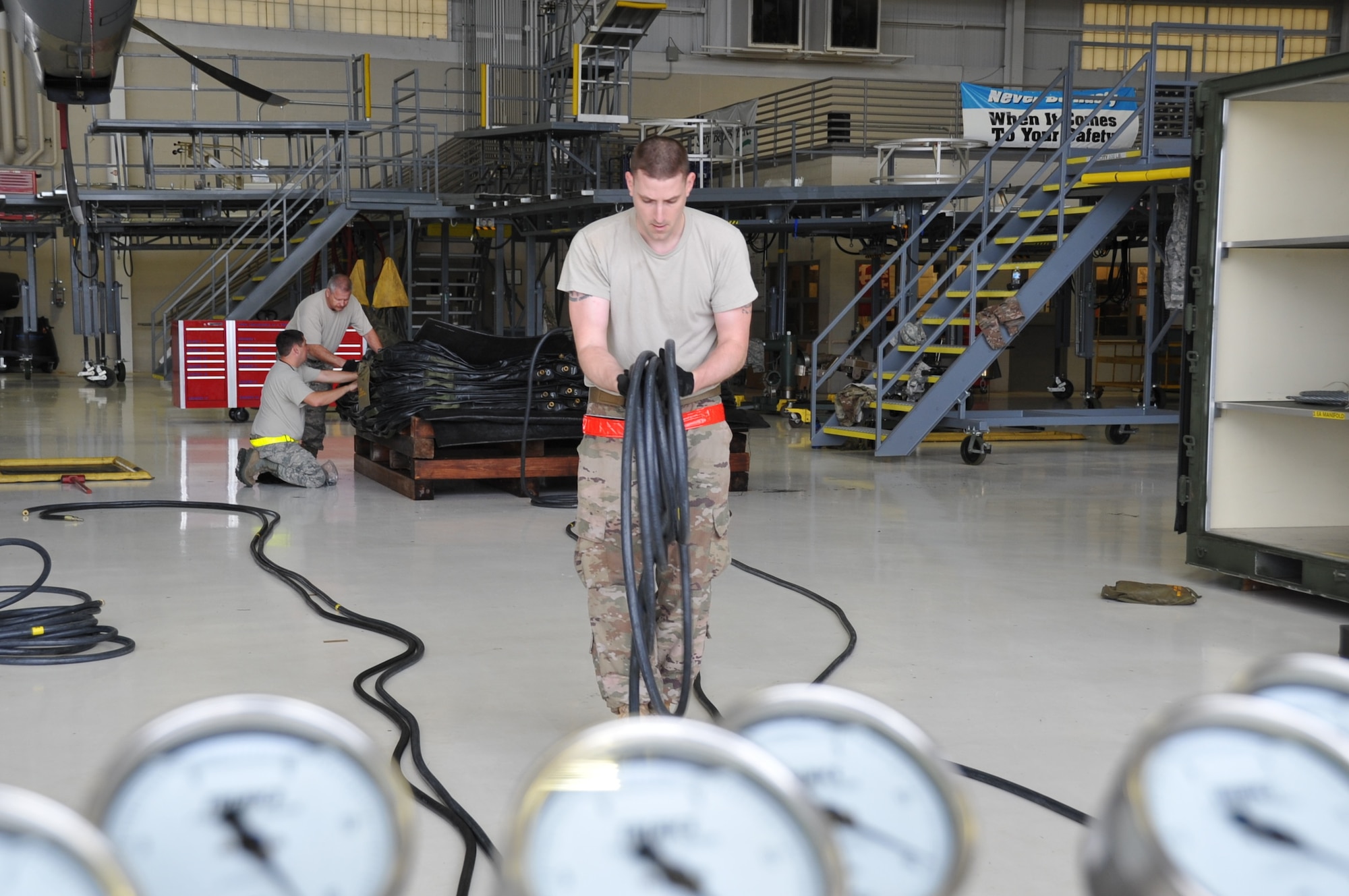 Tech. Sgt. Timothy Stevenson, 403rd Maintenance Squadron hydraulics back shop technician, unrolls a hose to attach to the air bags used to lift an aircraft. As a member of the 403rd Wing Crash, Damaged or Disabled Aircraft Recovery team, he participated in the annual training that is required to maintain proficiency and ensure that all equipment is serviceable and operational.  The CDDAR training was held during the March Unit Training Assembly at Keesler Air Force Base.   (U.S. Air Force photo by Master Sgt. Jessica Kendziorek)