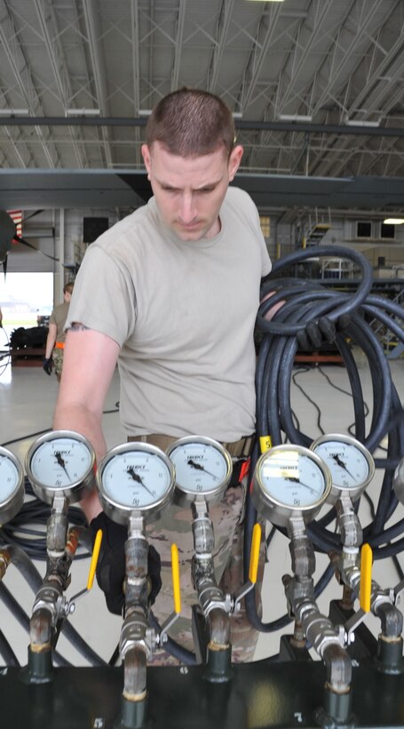 Tech. Sgt. Timothy Stevenson, 403rd Maintenance Squadron hydraulics back shop technician, attaches a hose to the control console manifold stand before unrolling  hose to attach to the air bags used to lift an aircraft. Members of the 403rd Wing Crash, Damaged or Disabled Aircraft Recovery team work together during a training exercise held during the March Unit Training Assembly at Keesler Air Force Base. The CDDAR training is an annual requirement to maintain proficiency and ensure that all equipment is serviceable and operational.  (U.S. Air Force photo by Master Sgt. Jessica Kendziorek)