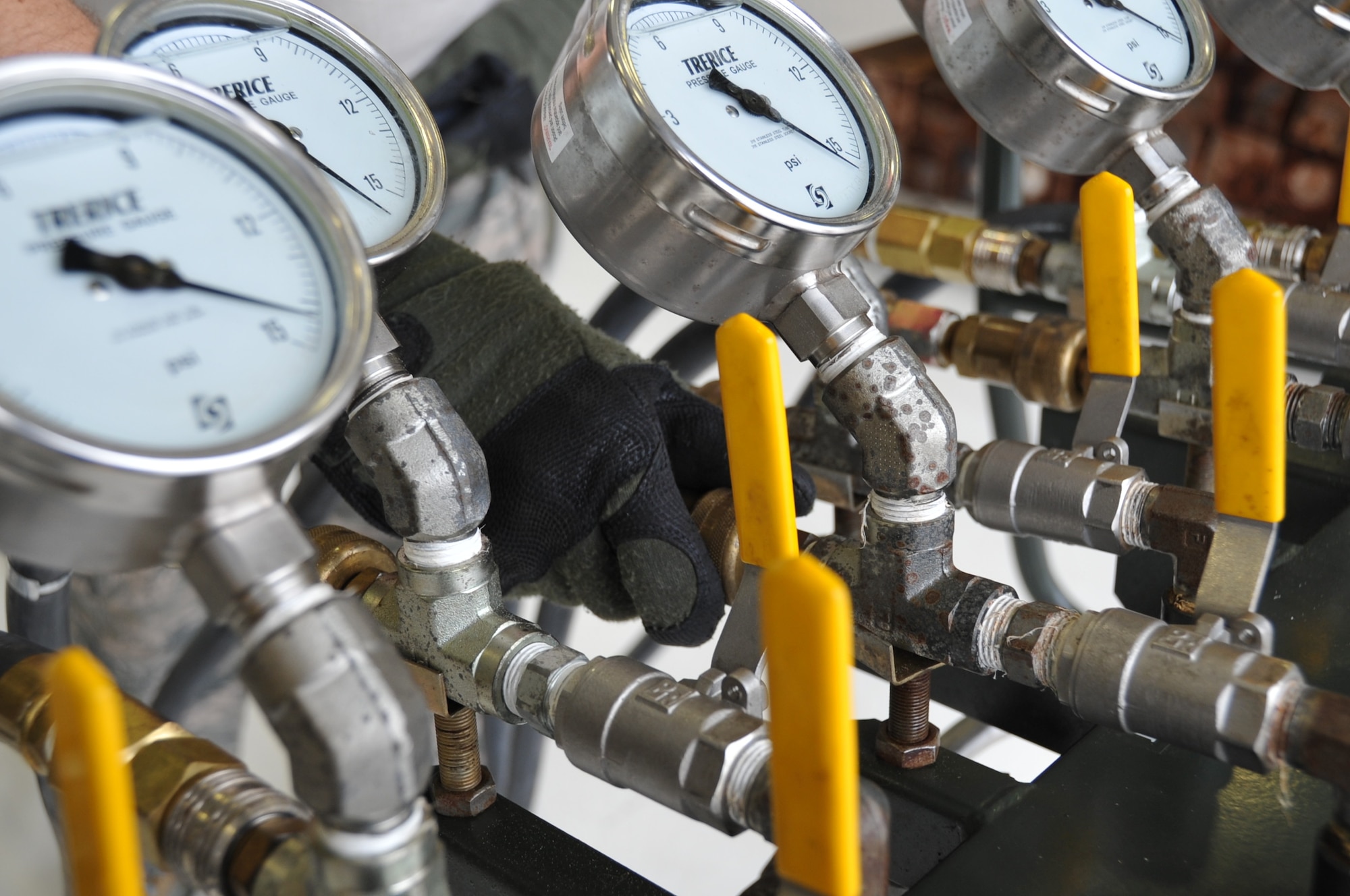 A member of the 403rd Wing Crash, Damaged or Disabled Aircraft Recovery team attaches a hose to the CDDAR control console manifold stand, before unrolling the hose to attach to an air bag used to lift an aircraft.  The CDDAR conducted an annual training exercise held during the March Unit Training Assembly at Keesler Air Force Base. This training is an annual requirement to maintain proficiency and ensure that all equipment is serviceable and operational.  (U.S. Air Force photo by Master Sgt. Jessica Kendziorek)