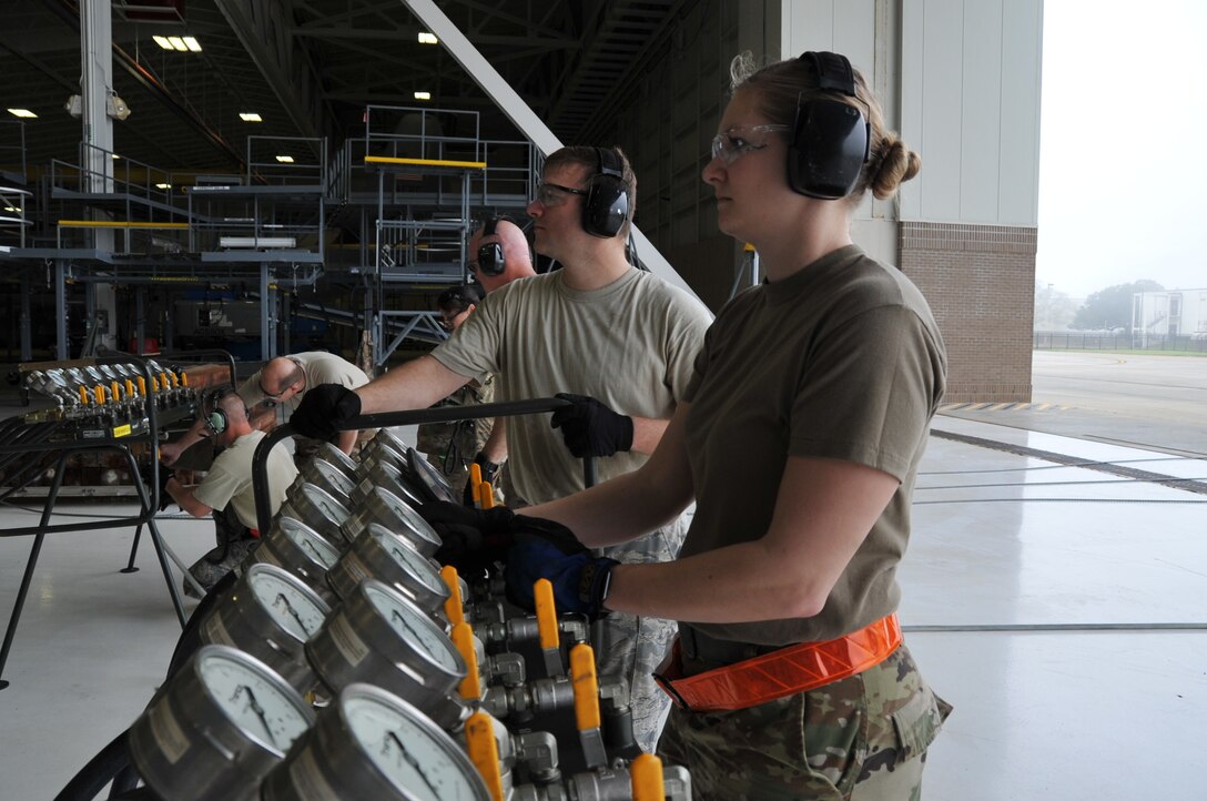 Staff Sgt. Victoria Kinman, 403rd Aircraft Maintenance Squadron crew chief, operates the control console manifold stand, releasing air into the air bags that are used to lift or stabilze an aircraft. Members of the 403rd Wing Crash, Damaged or Disabled Aircraft Recovery team work together during a training exercise held during the March Unit Training Assembly at Keesler Air Force Base. The CDDAR training is an annual requirement to maintain proficiency and ensure that all equipment is serviceable and operational.  (U.S. Air Force photo by Master Sgt. Jessica Kendziorek)