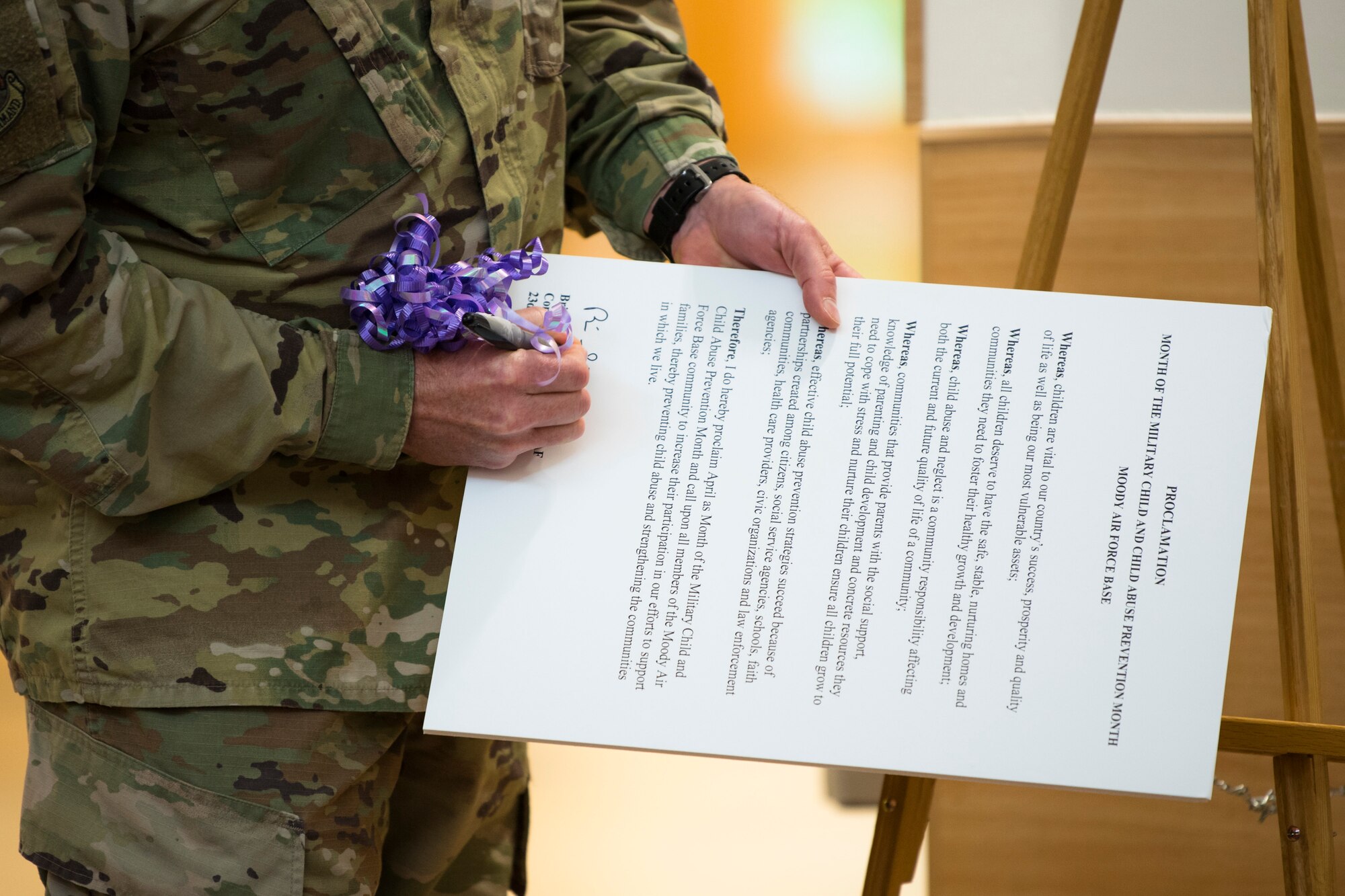 Col. Brian Stumpe, 23d Mission Support Group commander, signs a proclamation against child abuse, April 5, 2019, at Moody Air Force Base, Ga. April is designated as Month of the Military Child. The proclamation is designed to increase military members' participation in raising awareness of child abuse, preventing child abuse and strengthening the local community. (U.S. Air Force photo by Airman 1st Class Taryn Butler)