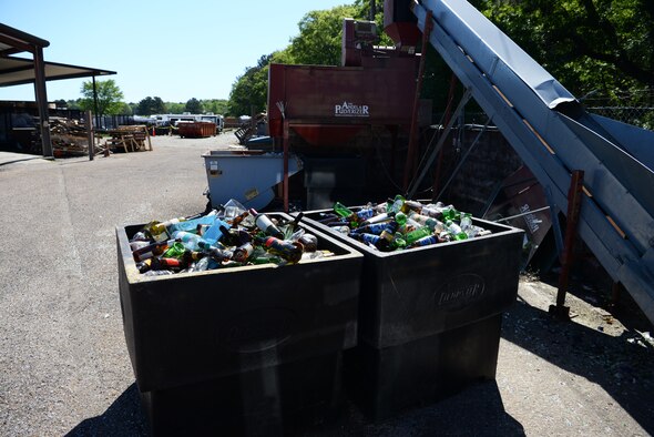 Bins full of glass next to a pulverizing machine, April 22, 2019, on Columbus Air Force Base, Miss. Once enough glass is collected at the recycling center, it is thrown into the machine and turned into sand and potting soil by pulverizing it down. (U.S. Air Force photo by Airman 1st Class Jake Jacobsen)