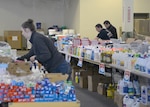 Members of the community stock shelves at the Sarpy-Cass Disaster Resource Center April 4, 2019, in Bellevue, Nebraska. The counties were heavily impacted by flooding in early March. (U.S. Air Force photo by D. P. Heard)