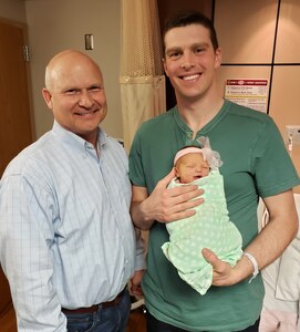 Air Force Capt. (Dr.) Andy Murtha holds baby Claire with Steve Mueller, Claire’s maternal grandfather, March 27, 2019 at Brooke Army Medical Center. The photo marks three generations of their family being born at BAMC.