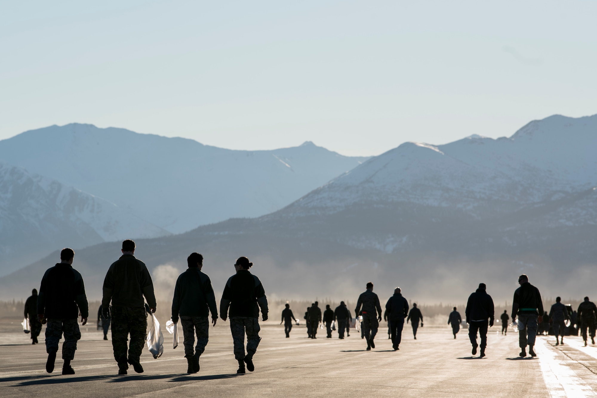 U.S. Airman from the 3rd Wing, 176th Wing, and 477th Fighter Group conduct a foreign object debris walk on the flightline at Joint Base Elmendorf-Richardson, Alaska, April 26, 2019. Airmen conducted the FOD walk to remove debris that could damage aircraft and hinder mission readiness.