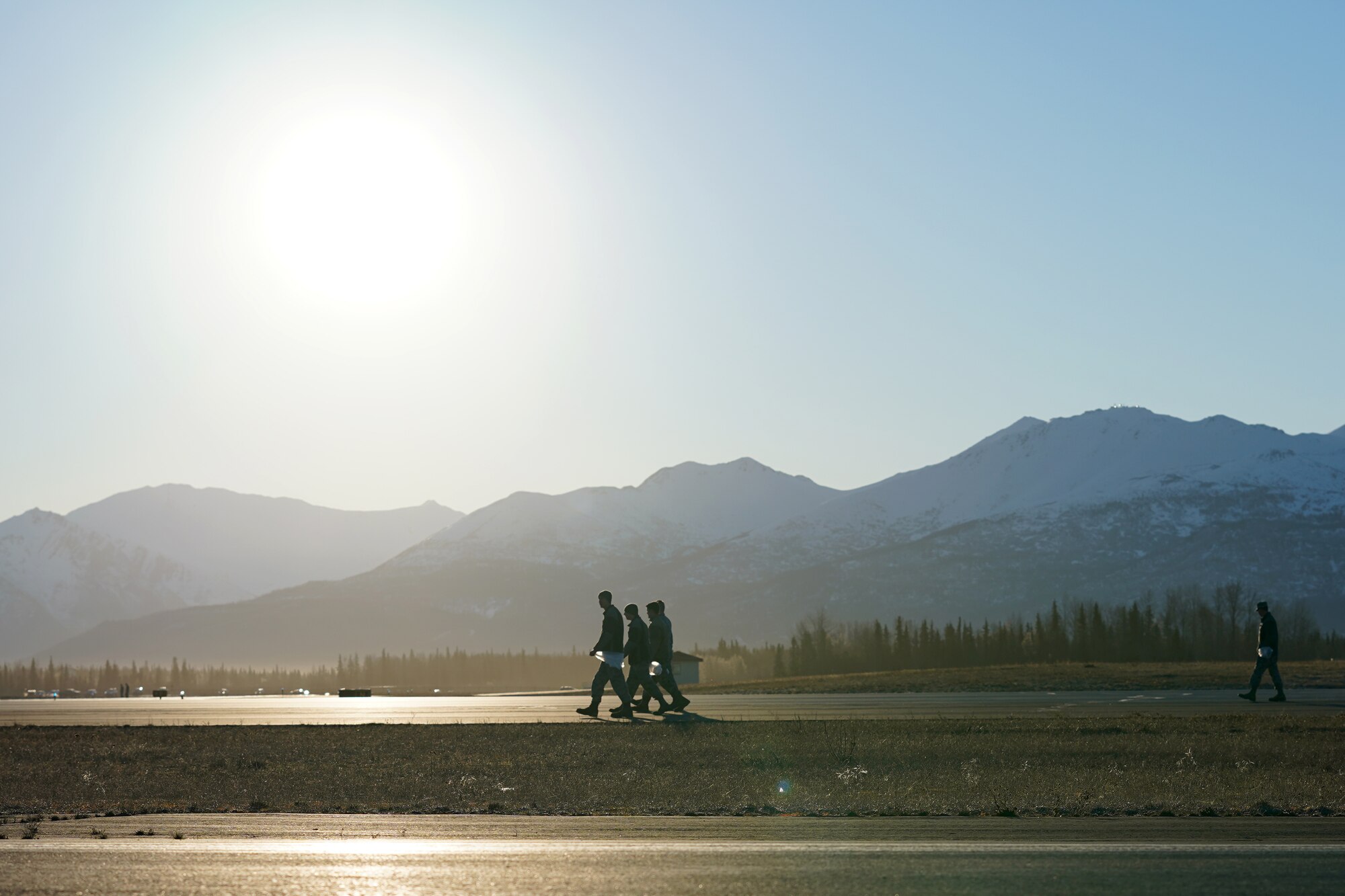 U.S. Airmen from the 3rd Wing, 176th Wing, and 477th Fighter Group conduct a foreign object debris walk on the flightline at Joint Base Elmendorf-Richardson, Alaska, April 26, 2019. The Airmen conducted the FOD walk to remove debris that could damage aircraft and hinder mission readiness.