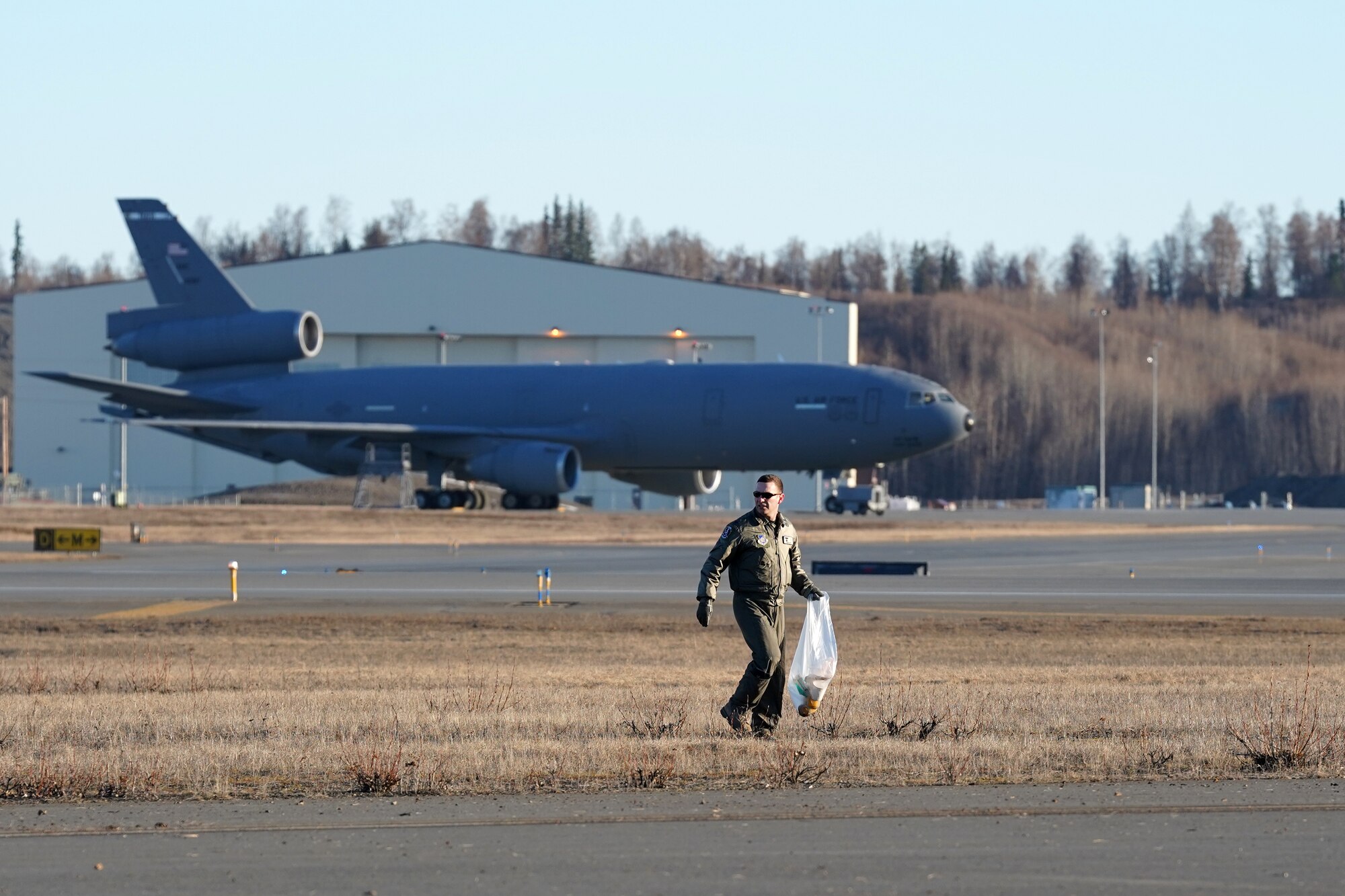 U.S. Airmen from the 3rd Wing, 176th Wing, and 477th Fighter Group conduct a foreign object debris walk on the flightline at Joint Base Elmendorf-Richardson, Alaska, April 26, 2019. The Airmen conducted the FOD walk to remove debris that could damage aircraft and hinder mission readiness.